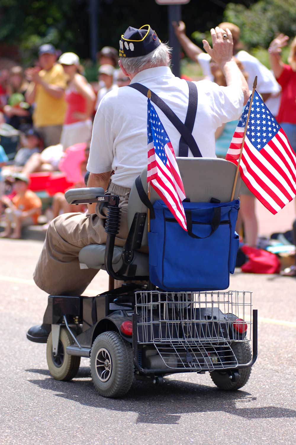 Veteran in a Parade Riding on a Scooter